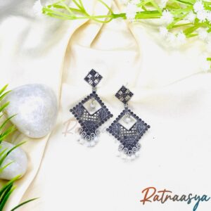 Pearl drop diamond oxidized silver earrings with geometric design and delicate pearl accents on white background