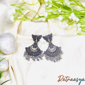 Butterfly motif oxidized silver earrings with floral and crescent design, hanging beads on white background