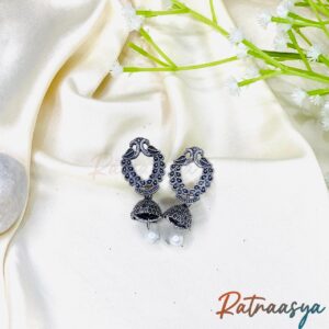 Twin bird oxidized silver jhumka earrings with detailed carving and pearl drops on white background