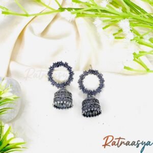 Elegant oxidized floral jhumki earrings by Ratnaasya displayed on a cream background with floral decor