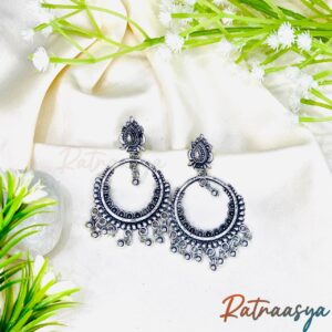 Classic oxidized chandbali earrings by Ratnaasya with crescent hoops and beaded fringe on a cream background