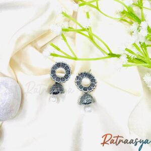 Pearl center floral oxidized jhumka earrings with intricate petals and pearl drop on white background